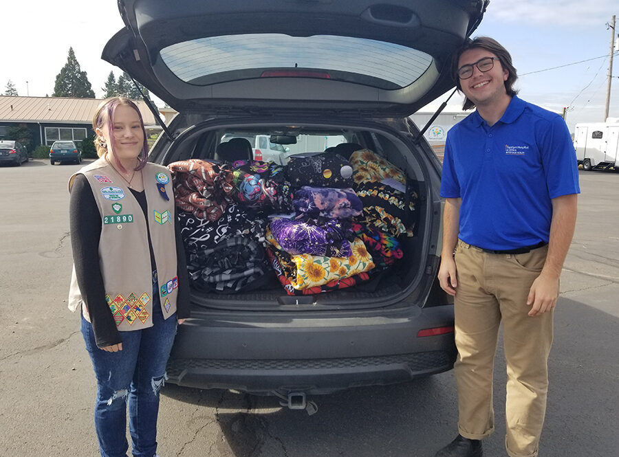 Girl Scout Mackenzie Grimes and Jake Bentz, the SIT distribution coordinator at Anthony Hall in Sublimity, with Mackenzie’s hand-made and donated blankets.