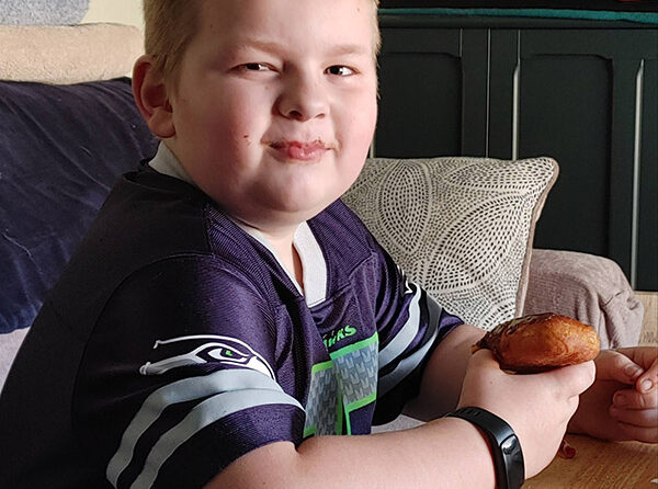 Kimra Tollefson’s son Zander enjoying his prize donut for an art contest at The Donut Hole in Stayton. Submitted Photo