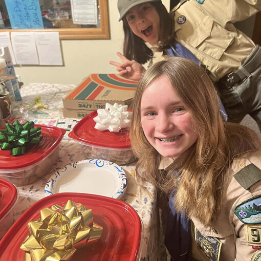 Kayla Webb, front, and Abigail Mauk of Boy Scout Troop 9050 get ready to deliver homemade cookies to the Santiam Outreach Community Center warming shelter in Mill City. The all-girls Troop is seeking more members from throughout the Santiam Canyon, from Aumsville to Gates.