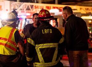Freres Engineered Wood President Rob Freres, right, gets an update from firefighters on the scene of June 23’s blaze at a Freres facility in Lyons.         Lyons Rural Fire Protection District