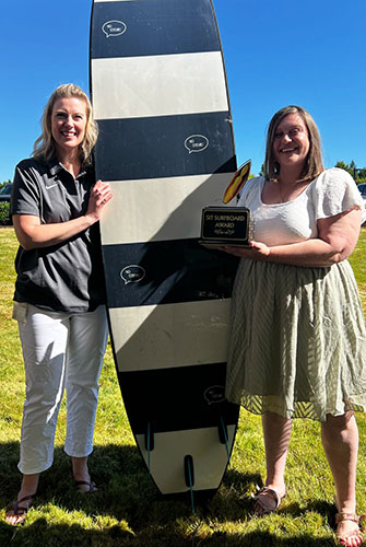 SSI coordinator, Kim Dwyer presenting Mid-Willamette Valley Community Action Agency resource coordinator Lisa Brunsin with the SIT Surfboard Award at the June end-of-year celebration. Submitted Photo