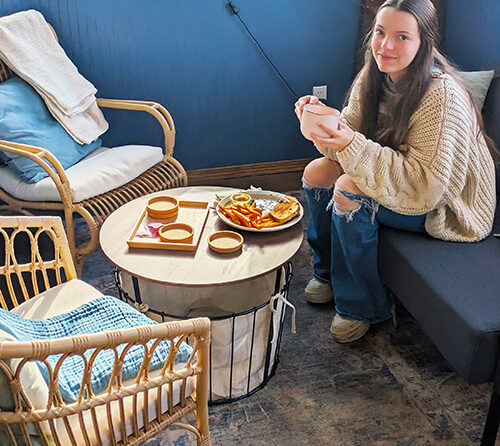 Stephanie, the daughter of All Good Things Café & Bakery’s owner Sarah Smith, in the cozy nook where patron’s can have a cup of tea or wait for a table. SUBMITTED PHOTO