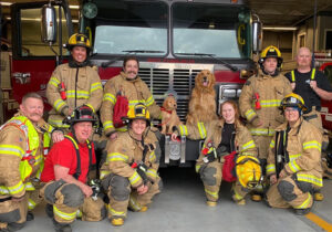 Sublimity Fire District pose with award winning comfort canines, Barney (just a pup at the time) and Probie in early 2023.