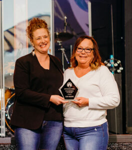 Chamber President Carmélle Bielenberg presenting Cari Sessums with the Distinguished Service – Individual of the Year Award.