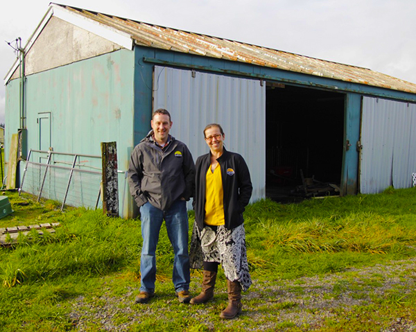 Agriculture education teacher Justin Brill and Assistant Principal Toni Wallisa are shown outside the “old barn” at Cascade High School. The school district has received a $190,000 grant that will allow it to replace the aging structure. Submitted Photo