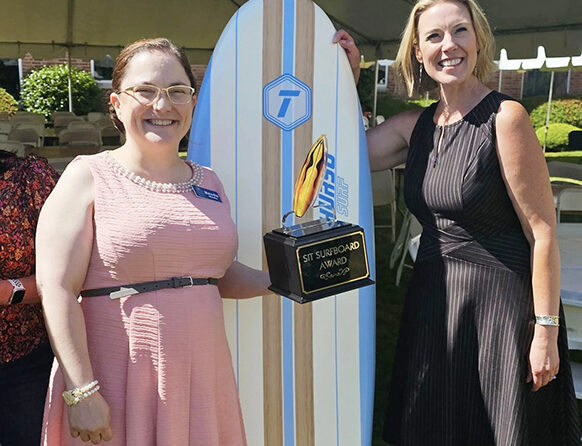 Melodie Weeks, left, shows off her Surfboard Award at the June 14, with SIT coordinator Kim Dwer. Submitted Photo