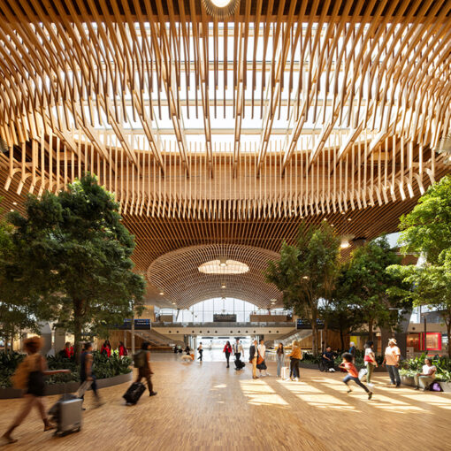 The mass plywood panels and other wood features at the upgraded Portland International Airport terminal can be easily seen in this interior view. Dozens of trees and thousands of plants were placed indoors to give the facility a forest feel. Courtesy Ema Peter