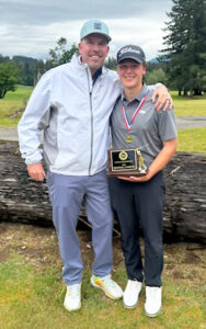 District golf champion Isaac Laro of Stayton is shown with Eagles coach Joseph Kiser at Tokatee Golf Club. Submitted  Photo