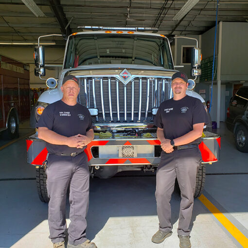 Former Division Chief Brad McKenzie, left,  and current Fire Chief Alan Hume are shown last summer in front of the Sublimity Fire District’s new type 3 engine that came via a program from the Oregon State Fire Marshal. James Day
