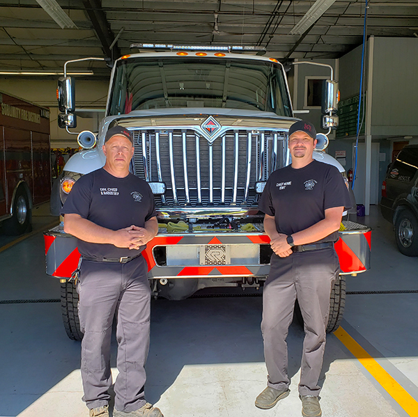 Former Division Chief Brad McKenzie, left,  and current Fire Chief Alan Hume are shown last summer in front of the Sublimity Fire District’s new type 3 engine that came via a program from the Oregon State Fire Marshal. James Day