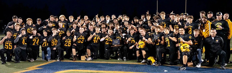 Cascade High football players and coaches shown after claiming the Class 4A state title on Nov. 29 with a resounding 52-0 win vs. Henley at Cottage Grove. Josiah Hawkins (center), holds the trophy. Coach Shane Hedrick is at far right.      