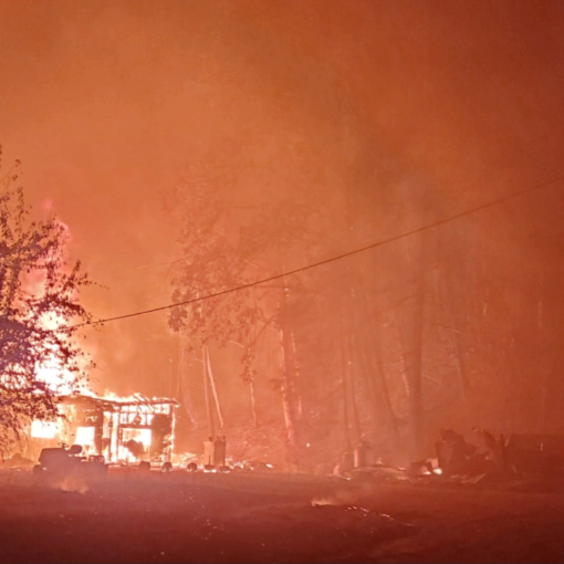 A picture of a burning building taken by Guy Edgerton as he and partner Dimond Edge evacuated the Santiam Fire in 2020. The couple had returned to their home in Mill City to retrieve medication left behind during their initial evacuation, and this image shows the intensity of the fire as they drove down Hwy. 22 back to Salem.